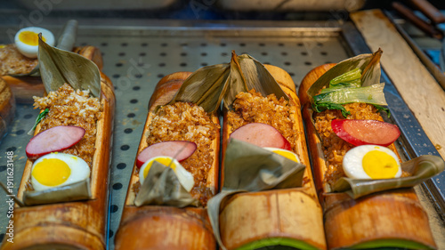 Local food and snacks including pork, Scallion Oil Noodles, intestines and seafood brochettes displayed in a popular market at night, Shanghai, China.