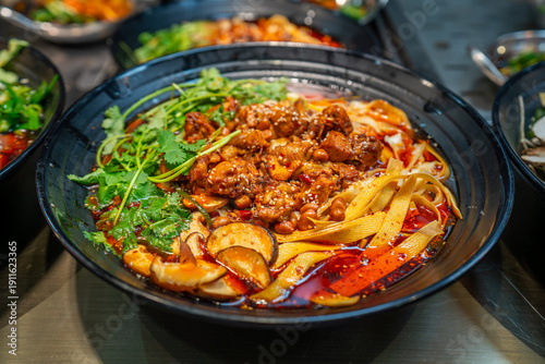 Local food and snacks including pork, Scallion Oil Noodles, intestines and seafood brochettes displayed in a popular market at night, Shanghai, China.
