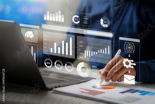 Tableau sur toile Businessman analyzing financial data on a virtual dashboard with charts and graphs