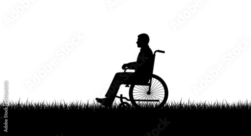 Silhouette of a man in a wheelchair outdoors.