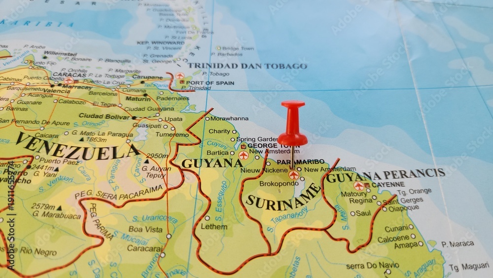 Naklejka premium View of Paramaribo, is the capital and largest city of Suriname, located on the banks of the Suriname River in the Paramaribo District, on a geographical map of America, marked with red push pin
