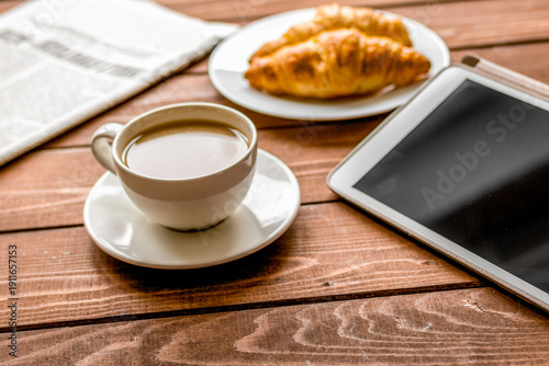 Businessman lunch at home with coffee, croisant and device