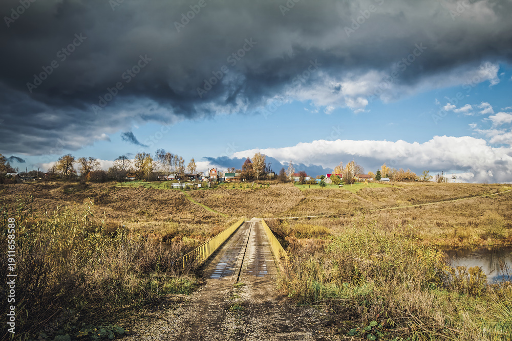 Obraz premium A small village in autumn on the other side of the river