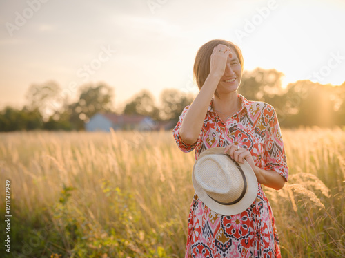 Εκτύπωση καμβά Young woman walking through picturesque European field in late summer
