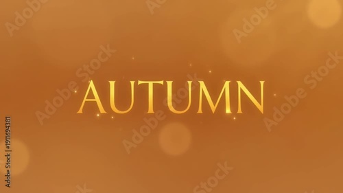 Autumn Text in Golden Yellow on Warm Orange Background with Soft Focus and Bokeh for Seasonal Design