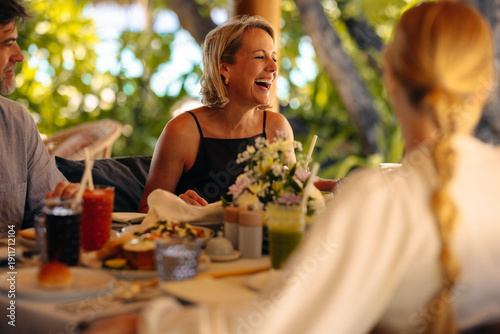 Joyful family gathers for a delightful holiday breakfast amidst a lush green backdrop