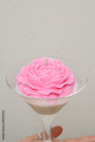 Wallpaper Mural A decorative candle with a pink wax flower on a woman's palm Torontodigital.ca