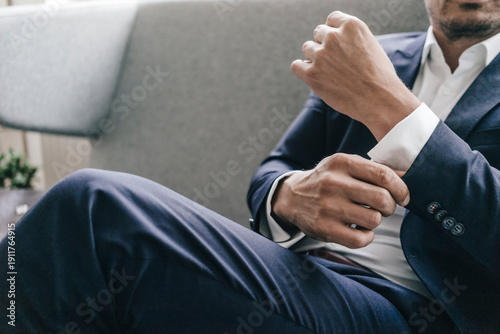 Close-up of businessman adjusting his sleeves