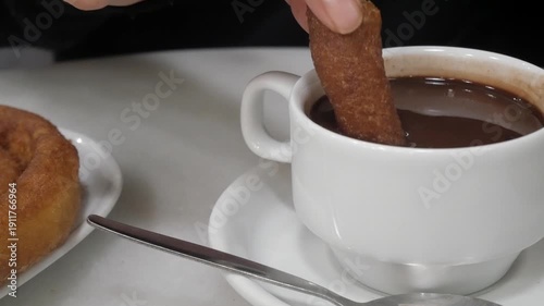 Churros dipped in hot chocolate, cozy cafe in Madrid, comforting moment