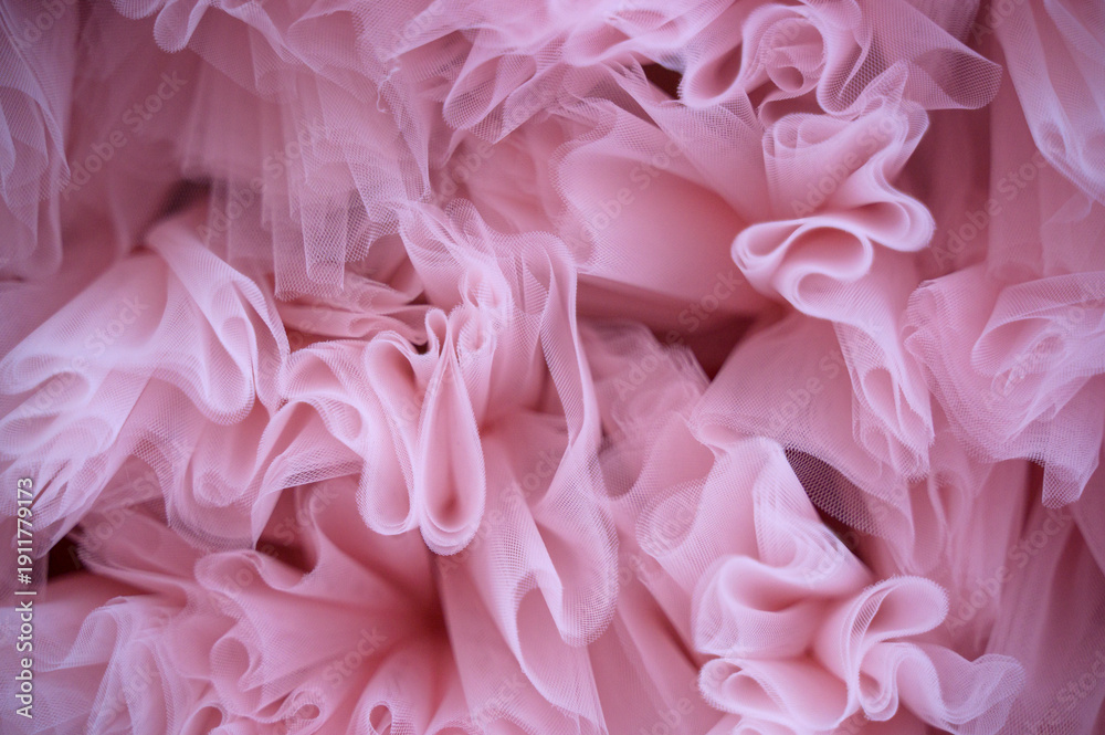 Fototapeta premium Pink ruffled fabric structure with delicate layers and soft waves