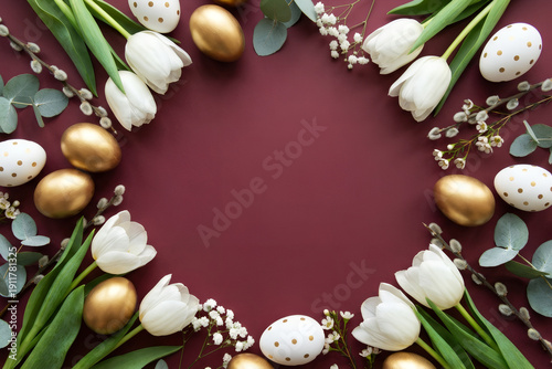 Frame from golden eggs, white tulips on red background. Greeting banner for spring Easter day, a Christian holiday with copy space.