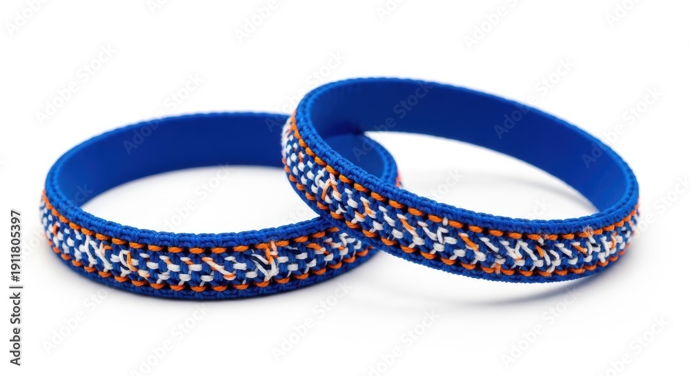 Fototapeta premium Two vibrant blue silicone bracelets with intricate woven patterns displayed against a white background