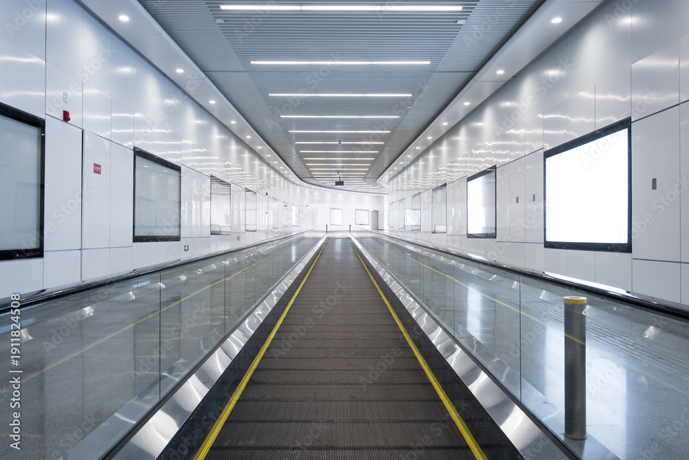 Obraz premium Modern airport moving walkway in an empty, spacious indoor corridor with sleek design