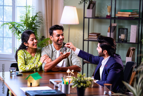 Fotografie First home key handover to happy couple after successful real estate agreement