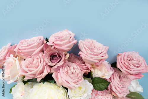 Blooming pink rose flowers bouquet on blue background for Mother's Day