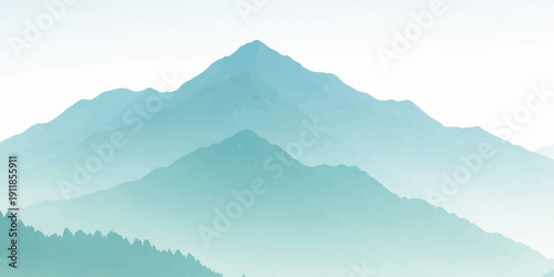 A misty mountain landscape at sunrise featuring a forest valley and peaks shrouded in blue fog under a cloudy sky