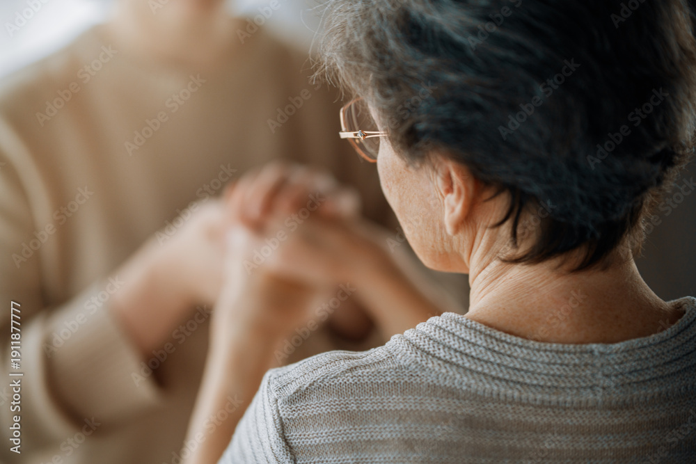 Fototapeta premium Caring Touch Between Generations: Hands in Warm Connection