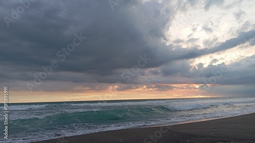 Natural coastal sunset panorama with reflective shoreline and dramatic sky, perfect for stock footage, relaxation media, cinematic intro sequences.