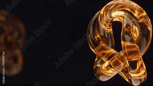 Seamless loop of rotating transparent yellow shape. 3d render of complex liquid glass knot with warm light reflections. Elegant luxury motion design background with blurred copy space.
