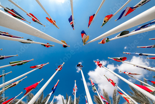 Photography flags of different countries on flagpoles, bottom view