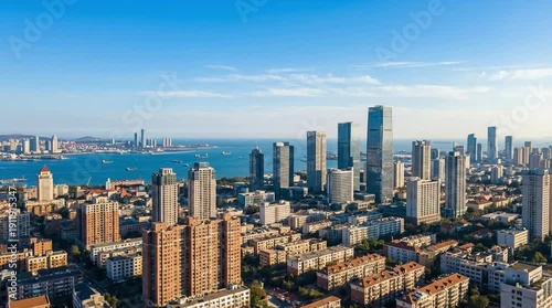 Coastal Metropolis Skyline: Panoramic Aerial View of Modern Skyscrapers, Urban Architecture, and Residential Areas by the Sea Under Blue Sky