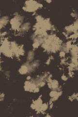 Brown and beige abstract tie dye pattern on dark background fabric texture