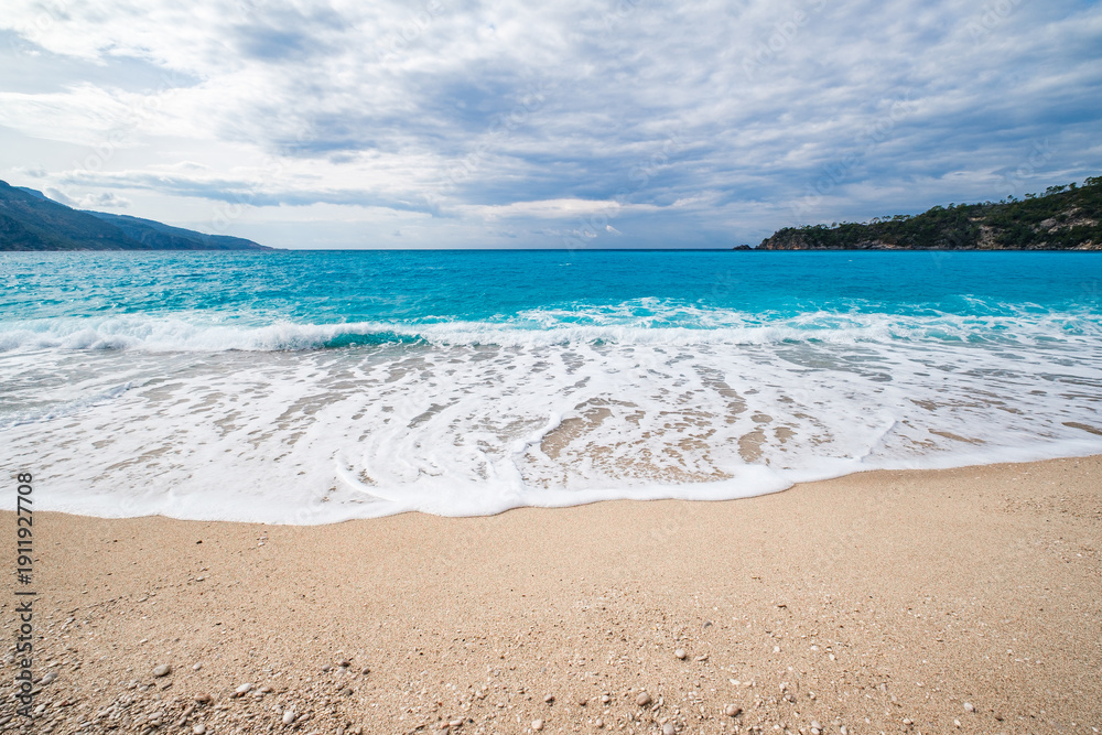 Fototapeta premium sandy coast and turquoise water in the sea, wide angle