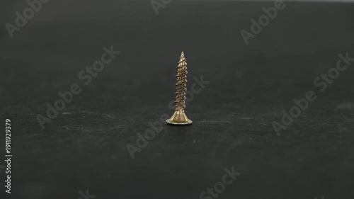 Close Up of Drywall and Wood Screws Turning in Motion