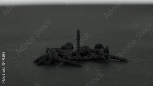 Close Up of Drywall and Wood Screws Turning in Motion