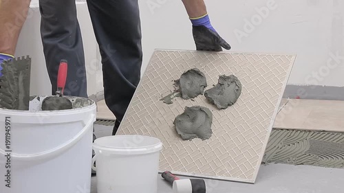 Close Up of Worker Installing Ceramic Floor Tiles