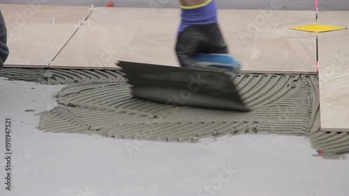 Close Up of Worker Installing Ceramic Floor Tiles