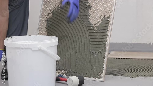 Close Up of Worker Installing Ceramic Floor Tiles