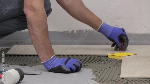 Close Up of Worker Installing Ceramic Floor Tiles