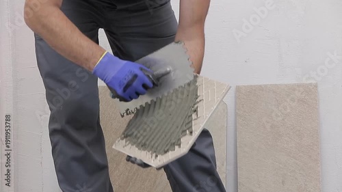 Close Up of Worker Installing Ceramic Floor Tiles