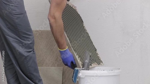 Close Up of Worker Installing Ceramic Floor Tiles