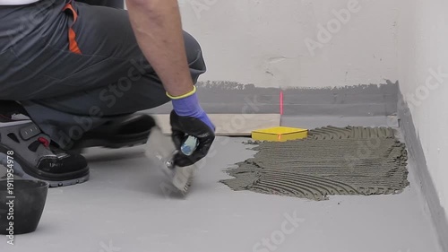 Close Up of Worker Installing Ceramic Floor Tiles