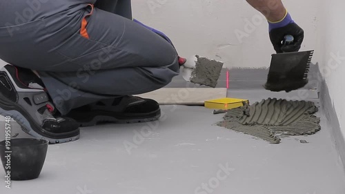 Close Up of Worker Installing Ceramic Floor Tiles