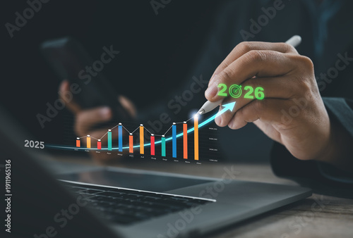 Professional analyzing market growth projection for 2026 with digital bar chart and upward trend. Concept of financial performance, revenue increase, economic forecast, strategic planning, and data dr
