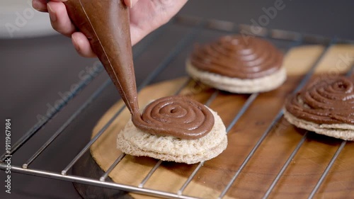 Piping Rich Chocolate Ganache Swirls onto Freshly Baked Cookies