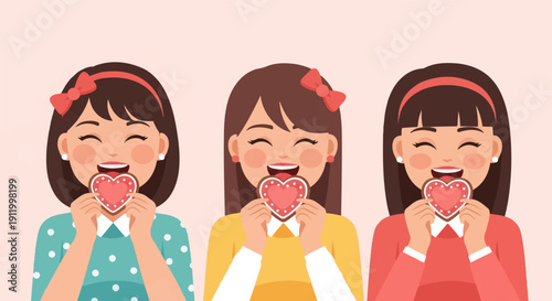 Three smiling girls holding heart-shaped cookies with happy expressions