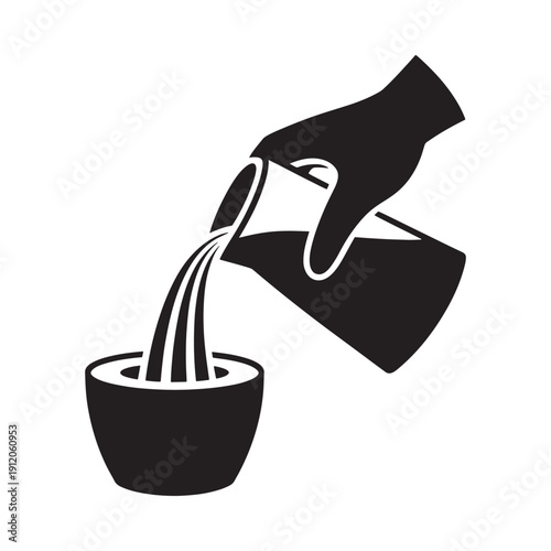 A hand pouring liquid from a pitcher into a bowl black and white