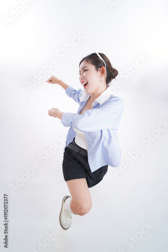 Photography Joyful Leap: A woman radiates happiness as she leaps with unbridled joy, her eyes wide with excitement and her body poised mid-air