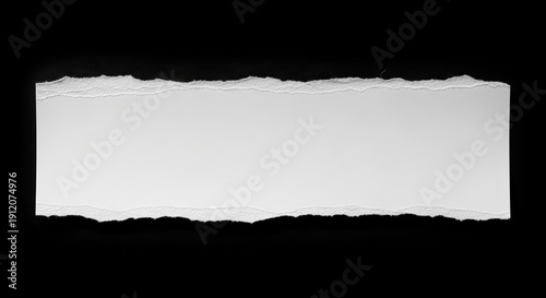 Torn paper edge isolated on black.