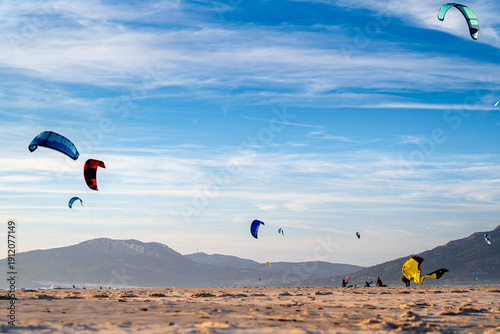 Kites and people on beach in Tarifa, holidays in Spain, Andalusia.