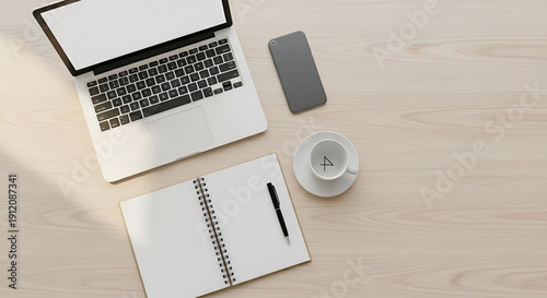 Modern workspace setup with laptop, notebook, and coffee on wooden desk
