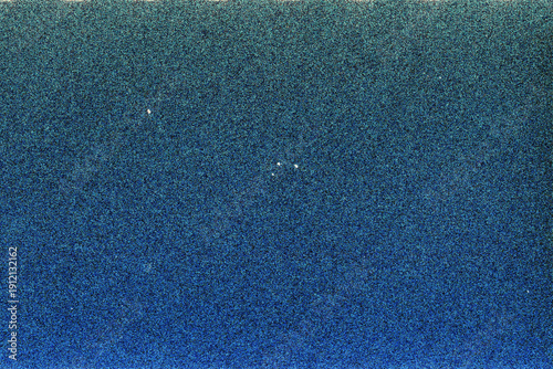 Blank grained film strip texture background with heavy grain, dust and light leak.