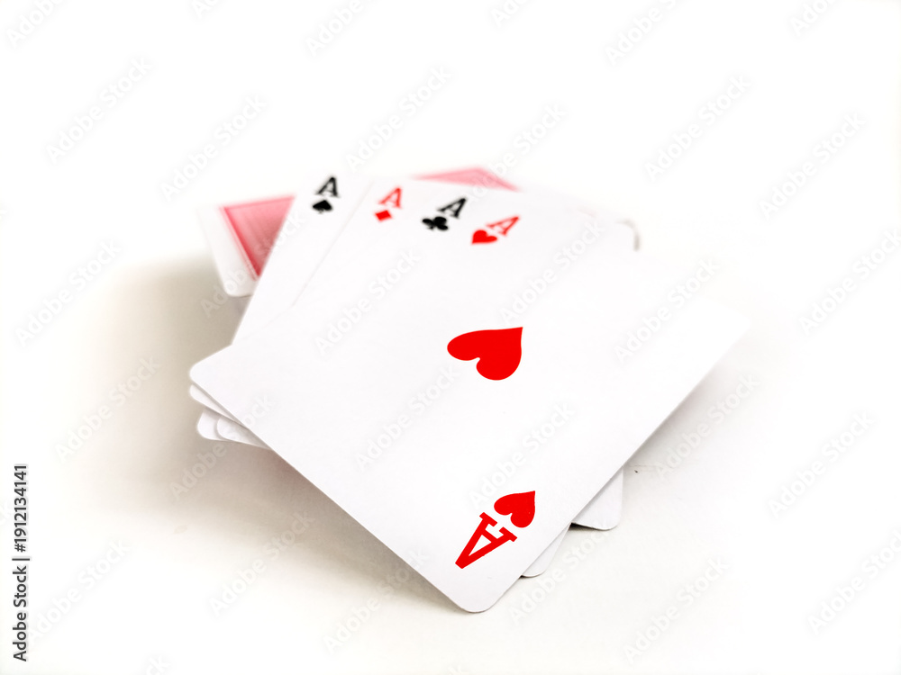 Obraz premium Four playing cards displaying the aces of hearts, clubs, spades, and diamonds are shown, fanned out on a white background.