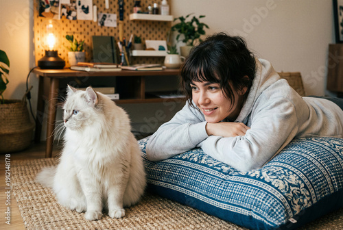 Woman lying on floor beside white cat in cozy living room with warm lighting and home decor. AI Generated.