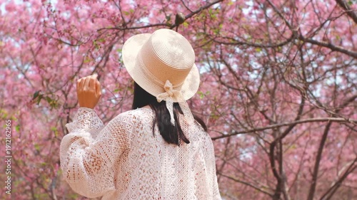 Wallpaper Mural Woman in White Hat Among Pink Cherry Blossoms Torontodigital.ca