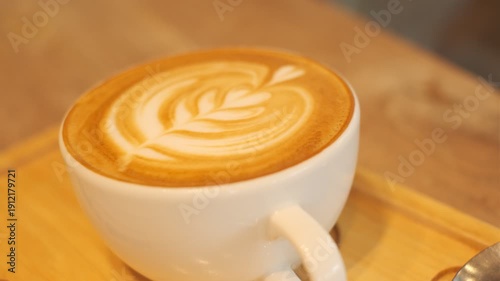 Wallpaper Mural A white coffee cup with a brown swirl on top sits on a wooden tray. The cup is filled with coffee. Concept of warmth and comfort Torontodigital.ca